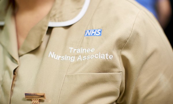 A close up of a nursing associate in an NHS uniform