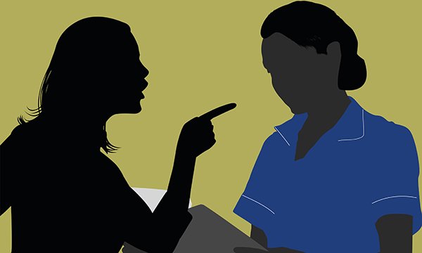 Ilustration shows the silhouette of a person who is acting in an aggressive manner as they point a finger at a nurse, who is quietly and politely standing in front of the person